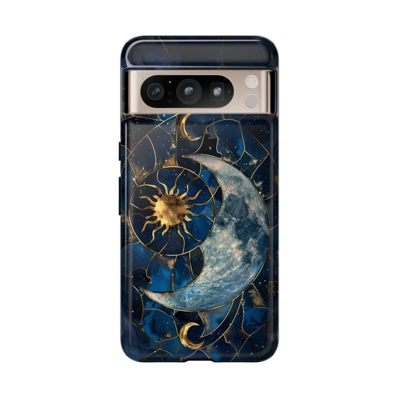 May include: A blue and gold phone case featuring a crescent moon and sun design. The case has a geometric pattern and a starry background.