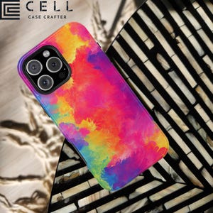 May include: A colorful phone case with a tie-dye pattern in shades of pink, yellow, blue, and green. The case is designed for an iPhone 12 Pro Max. The case is made by Case Crafter.