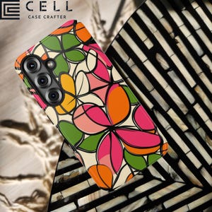 May include: A phone case with a floral pattern in shades of pink, orange, green, and yellow, outlined in black. The case is on a surface with a black and white striped design. The brand name "E CELL CASE CRAFTER" is visible.