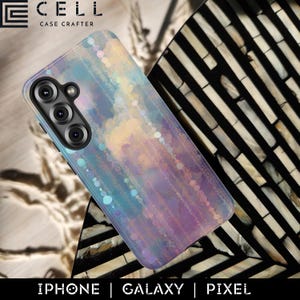 May include: A smartphone case with a colorful, abstract design in shades of blue, purple, and yellow. The case has a glossy finish and features a camera cutout. The brand name "E CELL CASE CRAFTER" is visible at the top. The bottom of the case reads "IPHONE | GALAXY | PIXEL".