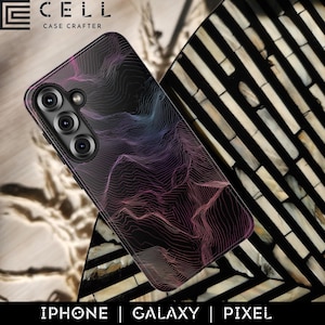 May include: A black phone case with a topographic map design in shades of purple, pink, and blue. The case has a glossy finish and features a camera array. The brand name "CELL CASE CRAFTER" is at the top. The bottom of the image reads "IPHONE | GALAXY | PIXEL".