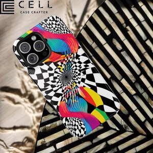 May include: A smartphone case with a vibrant, abstract design. The case features a black and white checkered pattern with a central spiral and colorful, flowing shapes in shades of red, blue, yellow, and green. The brand name "CELL CASE CRAFTER" is printed at the top.