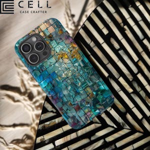 May include: A blue and green mosaic phone case with a geometric pattern. The case is designed for an iPhone with a camera bump. The case is on a black and white striped surface.