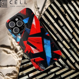 May include: A black smartphone case with a geometric design in red and blue. The case has a glossy finish and features the brand name "E CELL CASE CRAFTER" in white text. The case has a camera module with three lenses.