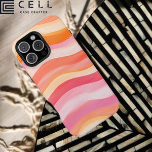 May include: A smartphone case with a colorful, wavy pattern in shades of pink, orange, and peach. The case has a glossy finish and a camera cutout. The brand name "E CELL CASE CRAFTER" is visible in the top left corner.