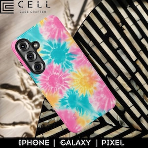 May include: A phone case with a vibrant tie-dye pattern in pink, yellow, and turquoise. The case has a camera module and the text "E CELL CASE CRAFTER". The bottom of the case has the text "IPHONE | GALAXY | PIXEL".