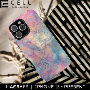 May include: A phone case with a floral design in pastel colors, including pink, blue, and purple. The case has a MagSafe feature and is designed for iPhone 13 and newer models. The brand name "E CELL CASE CRAFTER" is visible at the top.