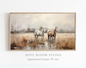 May include: A framed painting of two horses standing in a field of tall grass. The horses are a light brown and a white color. The background is a hazy, muted landscape with a small pond in the foreground.