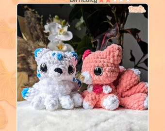 May include: Two crocheted plush toys, Kimmy the Kitsune, featuring one white fox with blue accents and one pink fox with white accents. Both have large, dark, glossy eyes and multiple tails. The text reads Crochet Pattern, Difficulty, and Kimmy the Kitsune.