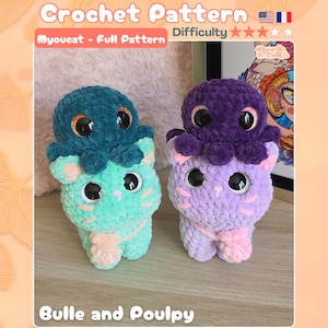 Puede incluir: Dos juguetes de ganchillo de felpa llamados Bulle y Poulpy. Uno es un gato verde menta con un pulpo azul cerceta en la cabeza. El otro es un gato morado claro con un pulpo morado oscuro en la cabeza. Ambos tienen ojos negros grandes y nariz.