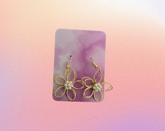 Gold look flower pearly centre dangly earrings