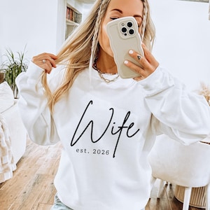 May include: A rustic wooden sign with the text "Welcome to our home" in white lettering. The sign features a distressed finish and a simple, inviting design, perfect for entryway decor.