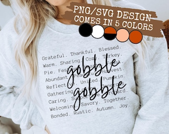 May include: A light gray sweatshirt with the words "gobble gobble" in a script font. The sweatshirt also has a list of Thanksgiving-themed words. The design comes in 5 colors.