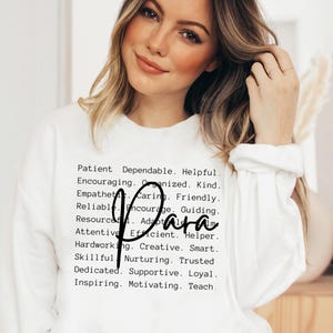 May include: White long-sleeve shirt with black text that reads "Patient. Dependable. Helpful. Encouraging. Organized. Kind. Empathetic. Caring. Friendly. Reliable. Encourage. Guiding. Resourceful. Adaptable. Attentive. Efficient. Helper. Hardworking. Creative. Smart. Skillful. Nurturing. Trusted. Dedicated. Supportive. Loyal. Inspiring. Motivating. Teach."