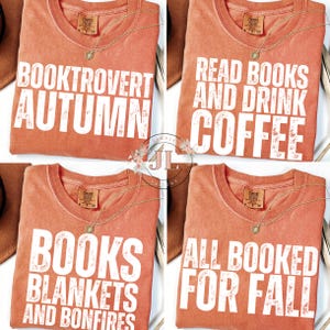 May include: Four orange Comfort Colors t-shirts with white text and a gold necklace. The shirts have different phrases: "BOOKTROVERT AUTUMN", "READ BOOKS AND DRINK COFFEE", "BOOKS BLANKETS AND BONFIRES", and "ALL BOOKED FOR FALL".