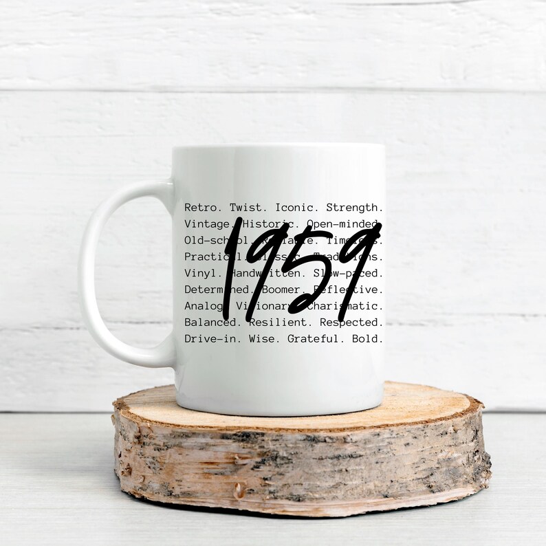 May include: White ceramic mug with the year "1959" in a handwritten style. The mug also features a list of words such as "Retro", "Vintage", and "Iconic". The mug is placed on a wooden coaster.