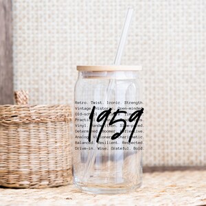 May include: A clear glass drinking cup with a wooden lid and a straw. The number "1959" is written in a bold, handwritten style on the cup. Text on the cup includes words like "Retro," "Vintage," and "Iconic."