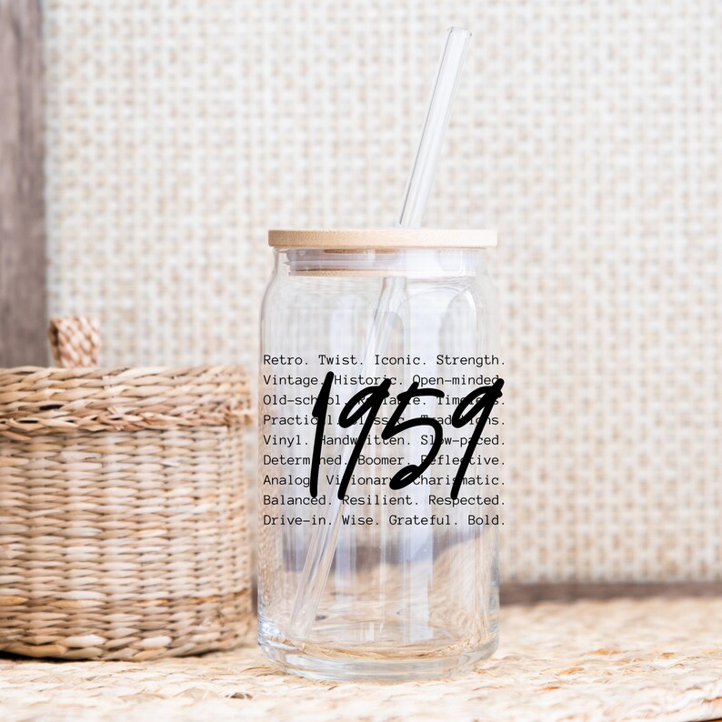 May include: A clear glass drinking cup with a wooden lid and a straw. The number "1959" is written in a bold, handwritten style on the cup. Text on the cup includes words like "Retro," "Vintage," and "Iconic."