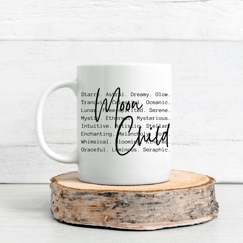 May include: White ceramic mug with a black design that reads "Starr. Astral. Dreamy. Glow. Tranquil. Celestial. Oceanic. Moon Lunar. Free-spirited. Serene. Mystic. Ethereal. Mysterious. Intuitive. Artistic. Stellar. Enchanting. Melancholy. Child. Whimsical. Blooming. Kind. Graceful. Luminous. Seraphic."