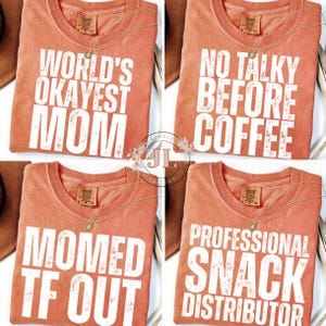 May include: Four orange Comfort Colors t-shirts with white text. The shirts have different phrases: "World's Okayest Mom", "No Talky Before Coffee", "Momed TF Out", and "Professional Snack Distributor". Each shirt has a gold necklace.