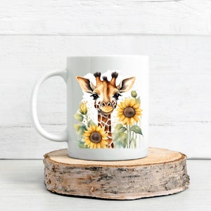 May include: White ceramic mug featuring a watercolour illustration of a giraffe's face surrounded by sunflowers.