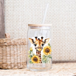 May include: A clear glass jar with a wooden lid and a straw. The jar features a sticker of a giraffe's face surrounded by sunflowers.
