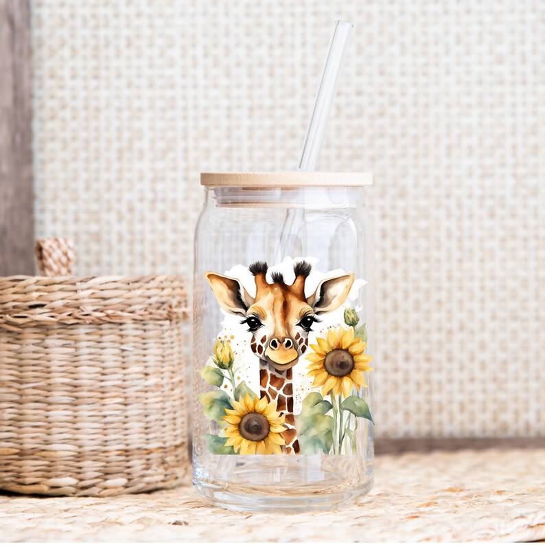 May include: A clear glass jar with a wooden lid and a straw. The jar features a sticker of a giraffe's face surrounded by sunflowers.