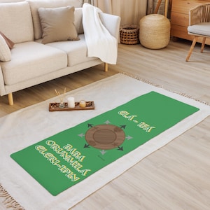 May include: A green yoga mat with a brown wooden circle in the center and yellow text that reads "Baba Orunmila Eleri-Ipin Ela-Ifa".