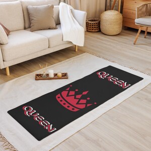 May include: Black yoga mat with a red crown and the word "Queen" written in white on either side of the crown.