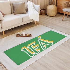 May include: A green yoga mat with the name "LEA" written in white and yellow letters.
