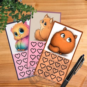 Pode incluir: Três cartões ilustrados de desafios de poupança com animais de desenho animado. Cada cartão apresenta um animal diferente: uma coruja, um gato e um gato laranja fofo. Os cartões têm caixas em forma de coração para rastrear a poupança. Uma caneta preta repousa sobre a superfície de madeira.