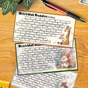 May include: Three "BrickWall Buddies Challenge" savings trackers with brick wall designs, each featuring a different cartoon character: a giraffe, a bunny, and a baby. A pen, money, and coins are also visible.