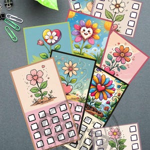 May include: A collection of colorful floral-themed cards with check boxes. Each card features a unique flower design with heart-shaped elements and vibrant colors. The cards are arranged on a gray surface, with a plant and office supplies in the background.