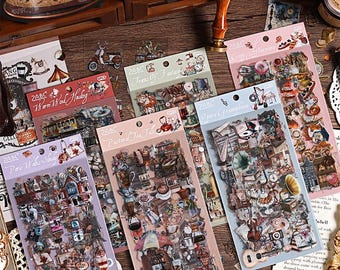 May include: A selection of decorative sticker sheets with vintage-style designs. The sheets showcase illustrations of teacups, musical instruments, and architectural elements. Each sheet has a unique colour scheme and text, including "Paris Wake Study" and "Opera Gramophone."
