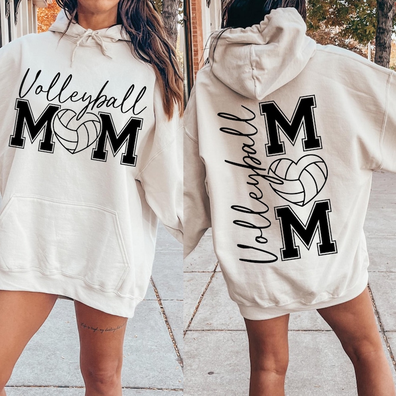 May include: A white hoodie with a black volleyball and the word "Volleyball Mom" printed on the front. The back of the hoodie has the words "Volleyball Mom" printed vertically with a volleyball in a heart shape.