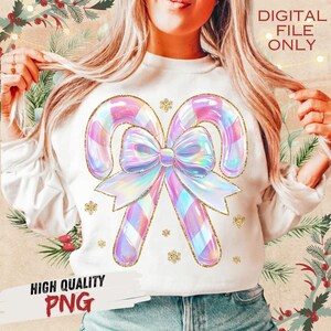 May include: White sweatshirt featuring a large, iridescent candy cane design with a bow and gold glitter accents. The text "DIGITAL FILE ONLY" is visible. The words "HIGH QUALITY PNG" are also displayed.