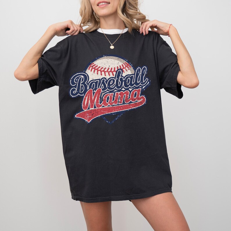 May include: Black oversized t-shirt with a vintage-style graphic of a baseball and the text "Baseball Mama".