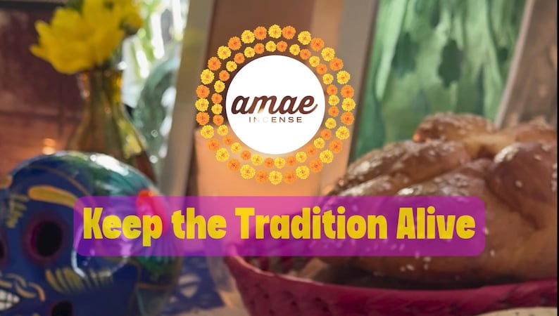 May include: A circular logo with the text amae INCENSE surrounded by orange and yellow marigold flowers. Below, a purple banner displays the yellow text Keep the Tradition Alive. A blue skull, yellow flowers, and a braided bread loaf are visible.