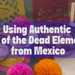 May include: A Day of the Dead altar display featuring yellow and pink paper cutouts, a woven basket, a small bowl of salt, a glass of water, a framed photograph, and a red skull mask, with the text Using Authentic Day of the Dead Elements from Mexico.