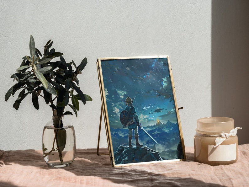 May include: A gold-framed picture with a fantasy landscape and a character holding a sword. The picture is on a table with a vase of greenery and a candle.