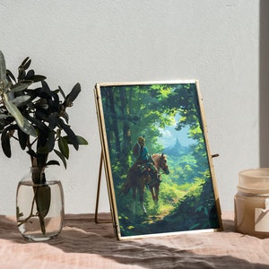 May include: A framed print of a video game character riding a horse through a forest. The print is in a gold frame and is sitting on a table with a candle and a vase of greenery.