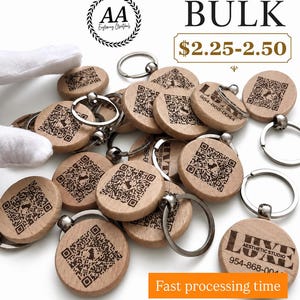 May include: A collection of round wooden keychains featuring laser-engraved QR codes and the text LUXE AESTHETIC STUDIO 954-868-0044. Each light-colored wooden disc is attached to a silver-toned metal split ring, creating a functional accessory set.