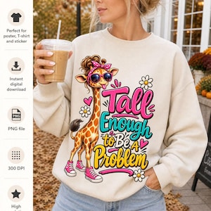 Peut inclure: Un sweat-shirt beige avec une illustration de girafe portant des lunettes de soleil roses, un bandeau rose et des baskets roses. La girafe tire la langue. Le texte indique Tall Enough to Be A Problem en lettres roses, turquoise et jaunes.