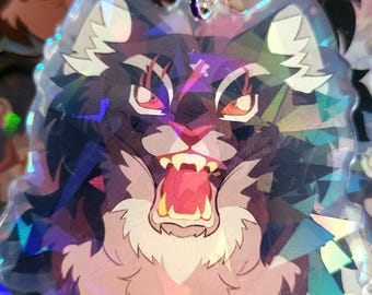 May include: A black and white cat with a white muzzle and a red mouth is shown with its mouth open and teeth showing. The cat is on a clear background with a rainbow iridescent effect.