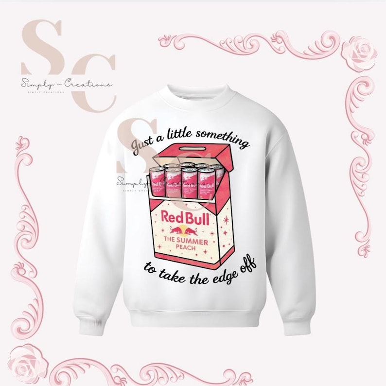 May include: White sweatshirt featuring a graphic of a Red Bull The Summer Peach box with cans. Text on the sweatshirt reads "Just a little something to take the edge off."