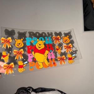 May include: A white ceramic mug with a black handle and the text "But First, Coffee" in a handwritten style. The mug is on a white surface. The mug is 4 inches tall.