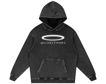 May include: Black hooded sweatshirt with a white halo and the text "UNLIKELY ANGEL" printed on the front.