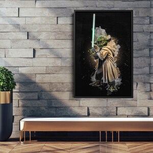 May include: A black and white digital art print of Yoda from Star Wars holding a green lightsaber. The background is a dark gray with white watercolor splatters.