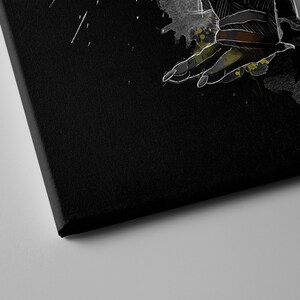 May include: A black canvas print with a white and gray illustration of a hand reaching out. The hand is surrounded by splatters of green and yellow paint.