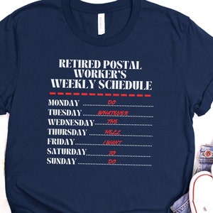 May include: A navy blue t-shirt with white text that reads "Retired Postal Worker's Weekly Schedule". The text is in a list format with days of the week and humorous activities for each day.